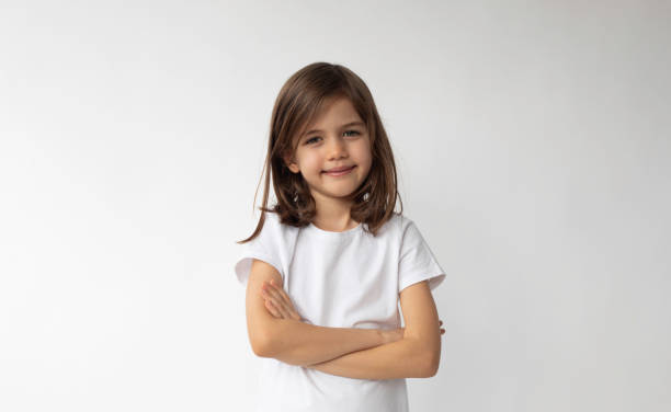istock Smiling Girl Standing with Arms Crossed 1467572872
