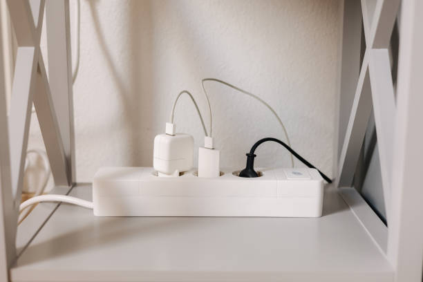 istock Modern cable connector for overloaded power boards at home. The extension cord is filled with sockets 1467573334
