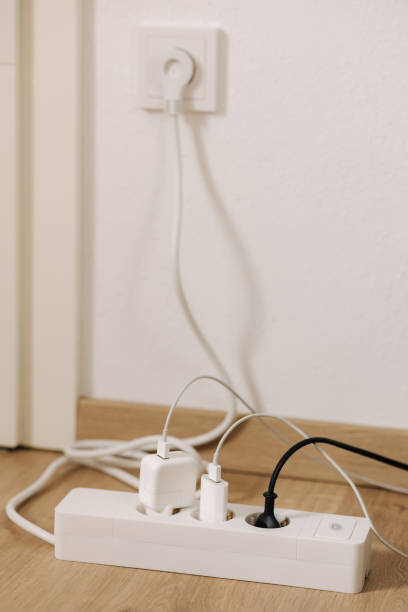 istock Modern cable connector for overloaded power boards at home. The extension cord is filled with sockets 1467574200