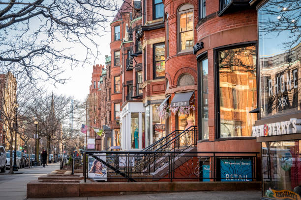 Street view of an old, red brick apartment building in Boston. Row of brownstones