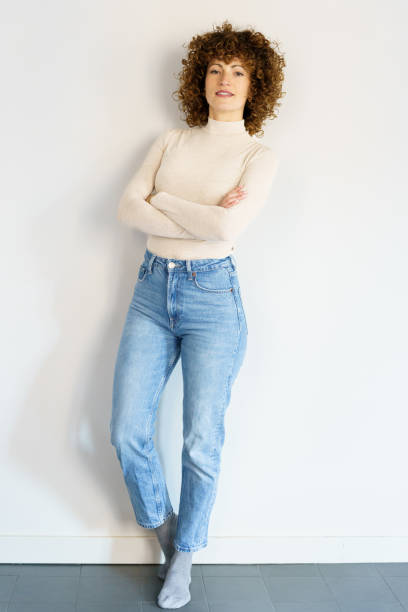 istock Confident woman standing against wall with crossed arms 1467574543
