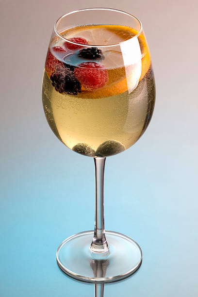 wine glass with white wine and fruit sangria stock photo