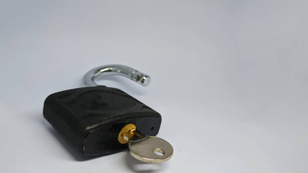 istock Unlocked padlock and key on the white background. 1467577542