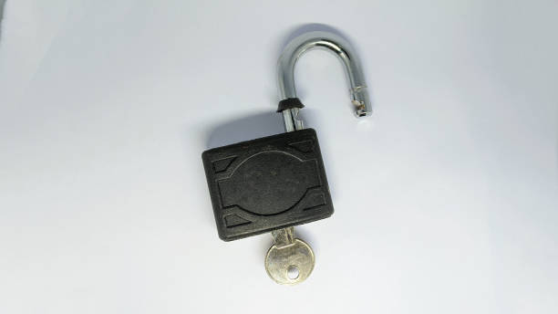 istock Unlocked padlock and key on the white background. 1467577771