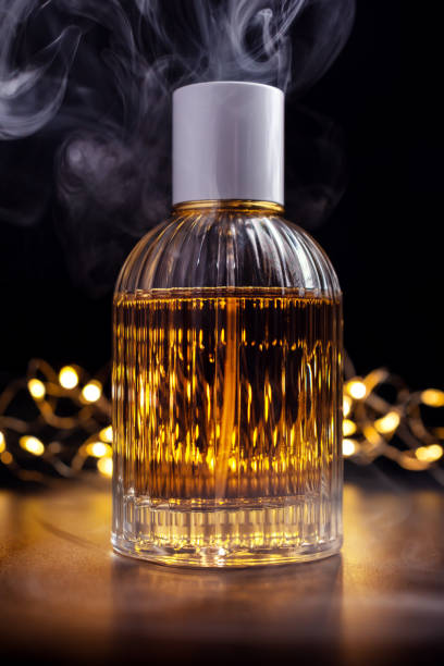 istock Glass bottle of perfume with smoke 1467577841