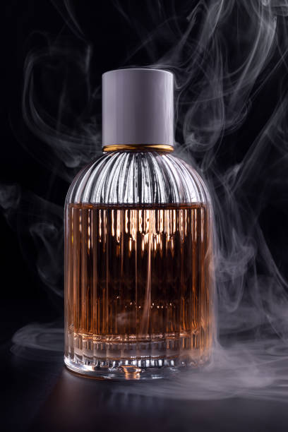 istock Glass bottle of perfume with smoke 1467577886