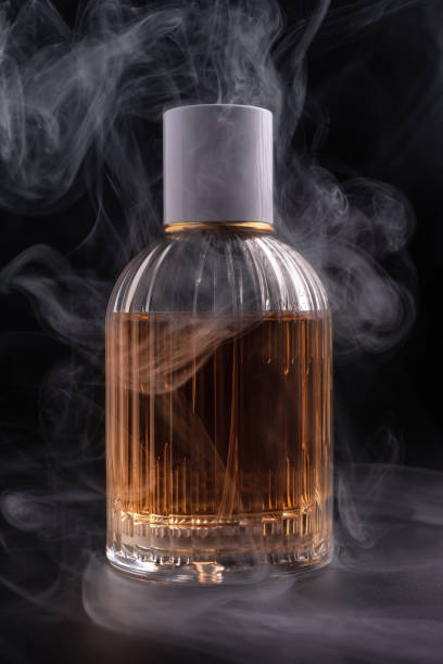 istock Glass bottle of perfume with smoke 1467577910