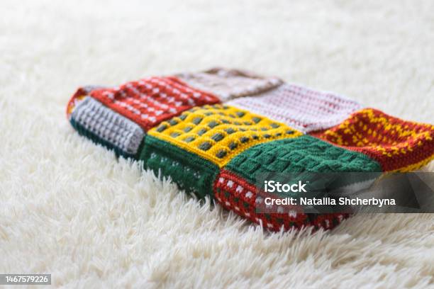 Knitted Warm Blanket On Bed Woolen Plaid On White Sofa Patchwork Plaid Cozy Room Interior Hygge Style In Bedroom Knitting Hobby Winter Coziness Concept Knitting Crochet Stock Photo - Download Image Now