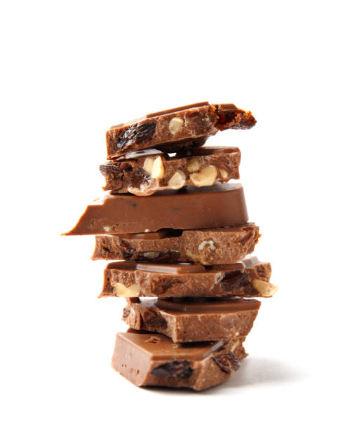 istock Pieces of chocolate bar with hazelnuts stacked on white background. 1467580399