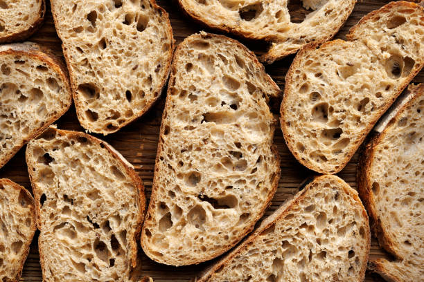 istock Sourdough bread slices on wooden background, top view. 1467580411