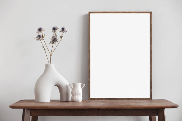 istock Artwork mockup in interior design. Blank white picture frame on a wall. Vertical orientation 1467584551