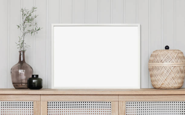 istock Artwork mockup in interior design. Blank picture frame on a wall, horizontal landscape orientation 1467584658