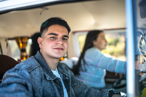 Portrait of young man inside a van