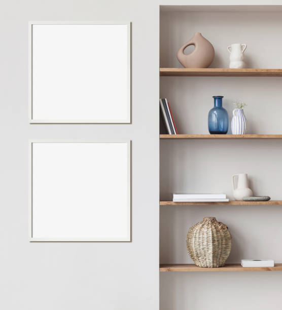 Two white blank picture frames on a wall. Artwork mockups in interior design. Square orientation
