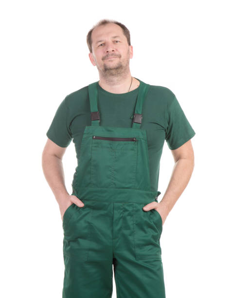 istock A worker in a green bib overalls keeps his hands in his pockets. 1467585265