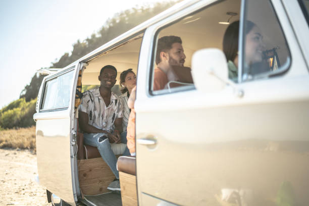 istock Group of friends on a journey inside a mini van 1467585423