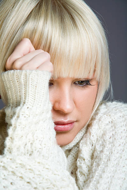 Blond woman with a serious look stock photo