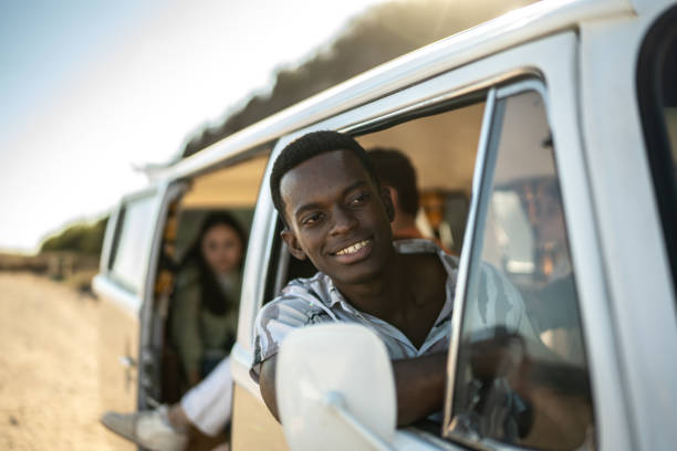 istock Young man looking away on a road trip in retro mini van 1467586541