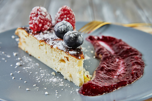 Cheesecake without dough with red fruit sauce.