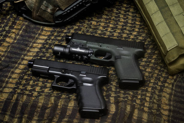 istock Glock 19 gen4 and gen5 model, Glock polymer pistol and popular handgun weapon with flashlight attachment olive green color and black. 1467587336