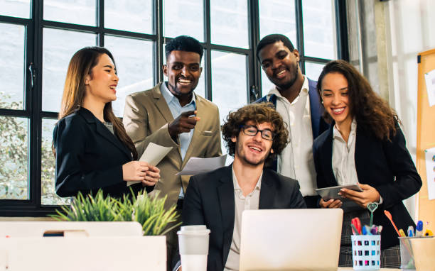 istock Diverse and multiracial smart businesspeople wearing formal suits, using computer, discussing by teleconference, brainstorming idea for company marketing plan in indoor modern office. 1467588939