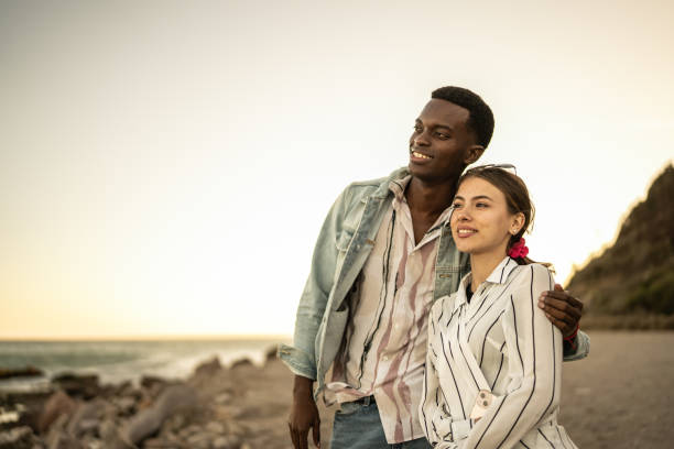istock Young couple looking away relaxing on the beach 1467589211