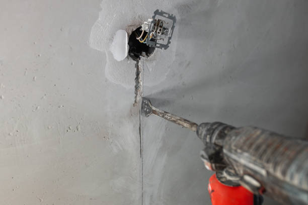 istock Chasing an installation channel in a concrete wall with an impact drill and attachments 1467589668
