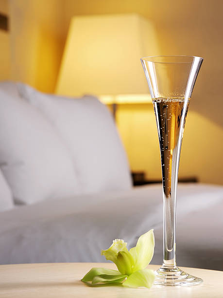 A flute of champagne in a bedroom stock photo