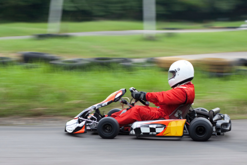 A go kart racer zooms past. Note slight motion blur with panning.