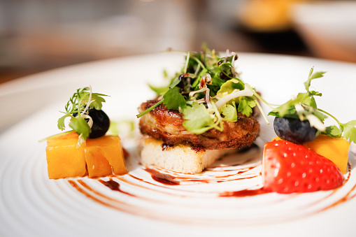 Foie Gras serving with toasted bread and Fruits