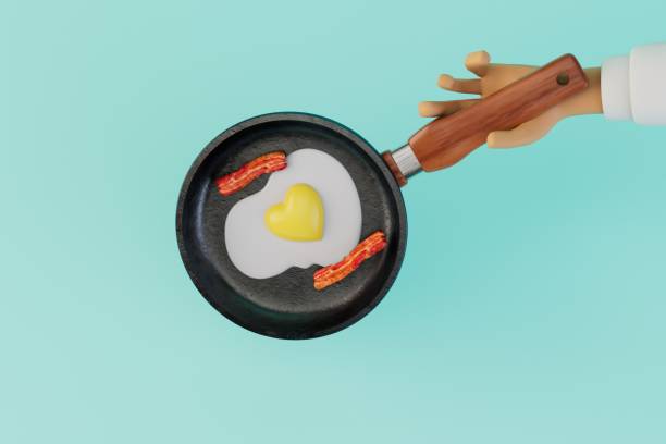 istock cooking breakfast. a hand in which a frying pan with scrambled eggs and sausages on a blue background. 3D render 1467592117