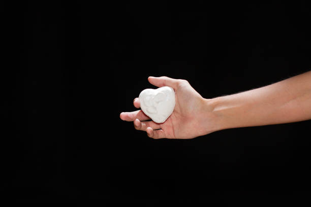 istock The hands of a man in white paint on a black background. 1467592491