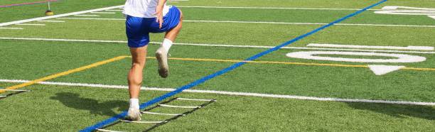 istock Football player running through a ladder on a turf field 1467594092