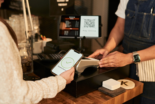 Customer using smart phone to pay online with a QR code to owner at coffee shop, E-commerce concept stock concept stock