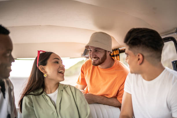 istock Young friends talking on retro mini van transport 1467600557