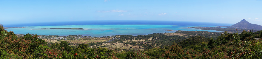 View from Mount Copolia over the east of Mahe, Seychelles with the capital Victoria and Eden Island, granite rock in the foreground.