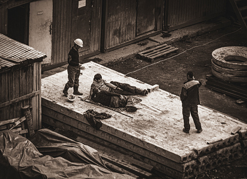 Moscow, Russia - september 11, 2012: construction workers have a rest on concrete slabs, black-white