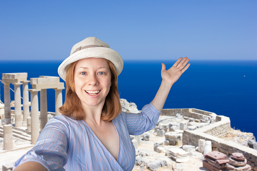 tourist taking selfie with landmarks, greek trip, tourist international trip,tourism and travel, happy woman in hat taking photo with ancient acropolis in Greece