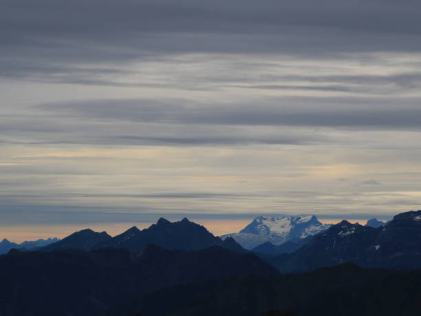 Grey clous over mountain ranges in Central Switzerland. stock photo