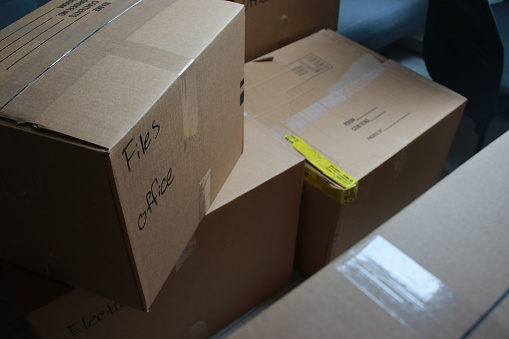 close up of moving cardboard boxes in a room