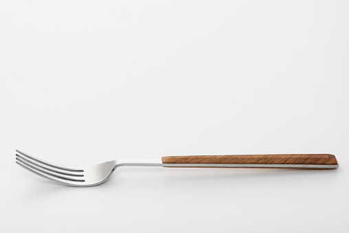 Wooden fork isolated on white background. Studio shot.