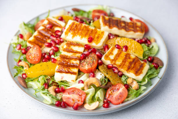 istock Warm salad with roasted halloumi cheese, nuts (cashews and almonds), cherry tomatoes, pomegranate, orange and arugula. Traditional oriental cheese 1467611186