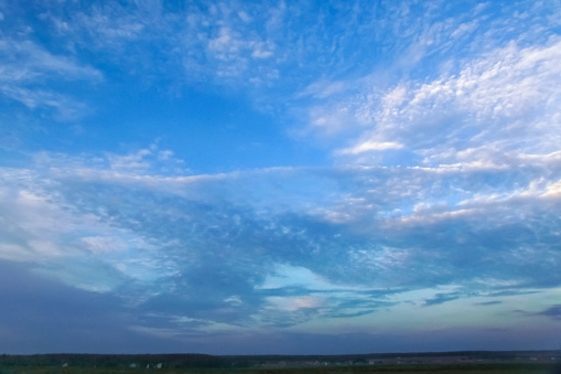 Soft white blurred clouds on a gentle blue sky on a sunny day. Wallpaper. Background. Beauty in nature