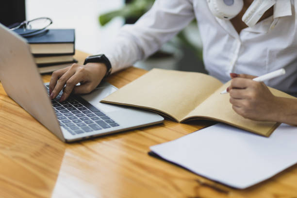 istock Businesswoman in office working with laptop and writing work schedule. 1467617831