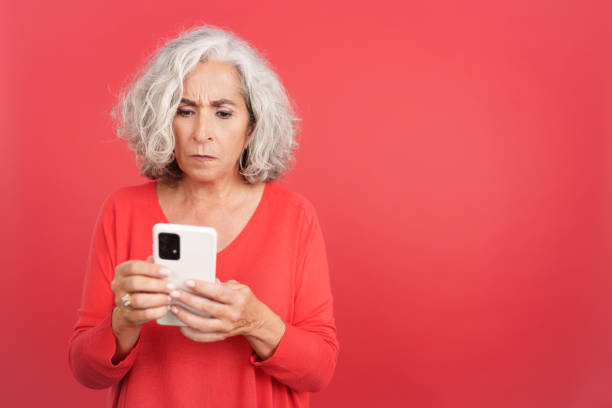 istock Worried mature woman using a mobile phone 1467624018