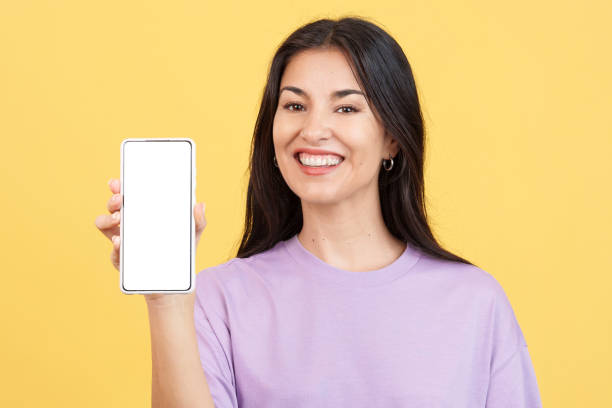 istock Happy woman holding a mobile with a blank screen 1467624645