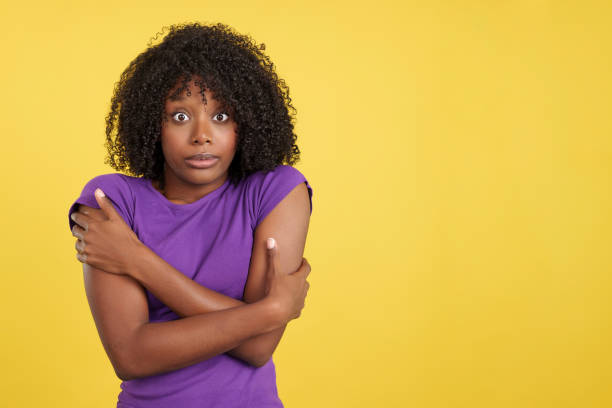 istock Woman with afro hair hugging herself gesturing coldness 1467624693