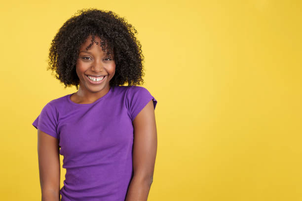 istock Cool woman with afro hair laughing while looking at camera 1467624741