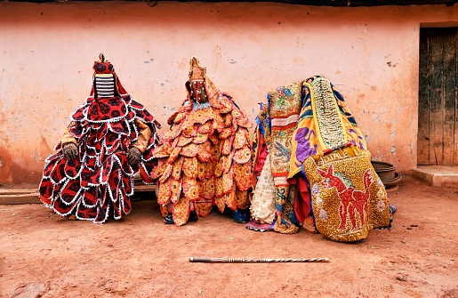 Abomei. Benin- mars 27-2021: A form of 'Egungun' spirit performs a dance ahead of a Voodoo ceremony and speaks quickly in squeaky voices they represent the ancestral.They take care of the comunity.