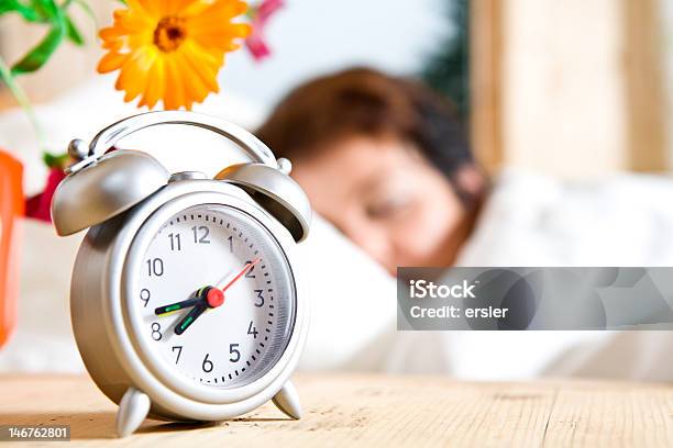 Woman Dreaming Through Her Wake Up Time Stock Photo - Download Image Now - Adult, Alarm Clock, Bed - Furniture